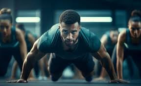 A man performing a push-up with others in a group workout, symbolizing gritty unconventional workouts that build mental toughness.