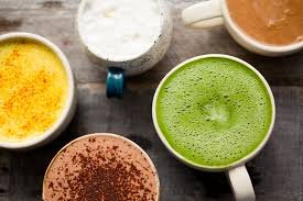 A variety of colorful caffeine alternative beverages in cups, including matcha, golden milk, and chicory coffee, symbolizing brain-boosting options.