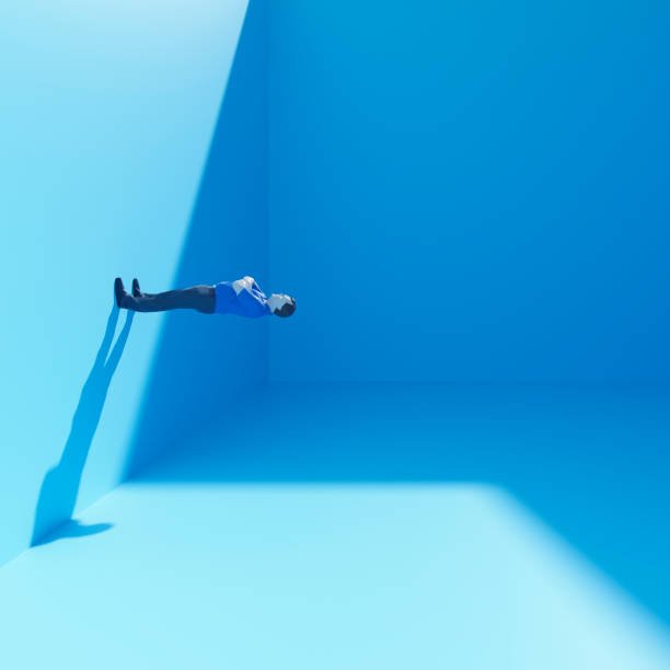 A man in a blue outfit floating horizontally in a minimalist, light blue room, casting a shadow on the wall, symbolizing solitude and mental clarity.