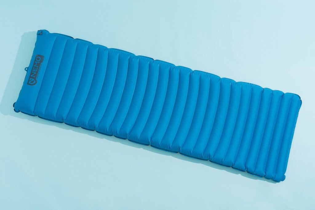 A compact inflatable sleeping pad or closed cell foam pad