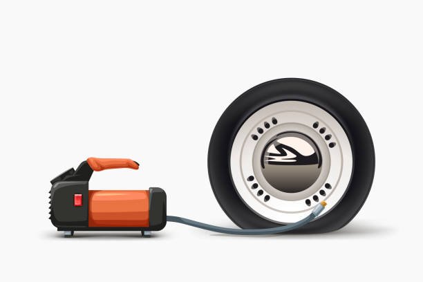 An illustration of a compact portable tire inflator connected to a car tire, ready to fix a flat.