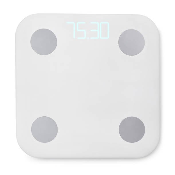 A modern white smart scale with four round metal sensors for body composition analysis, displaying a weight reading on its digital screen, shot from above on a white background.