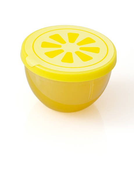 A yellow, lemon-shaped refrigerator deodorizer with a vented lid, designed to absorb odors and keep a kitchen fridge fresh.