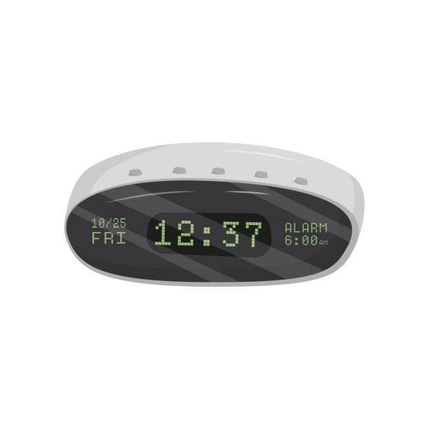 A modern small digital oval alarm clock with a green LED display showing the time, date, and alarm setting.