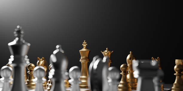 Luxury golden and silver chess pieces on a board, with the gold King centrally illuminated against a dark, dramatic background. Focus on premium Staunton design.